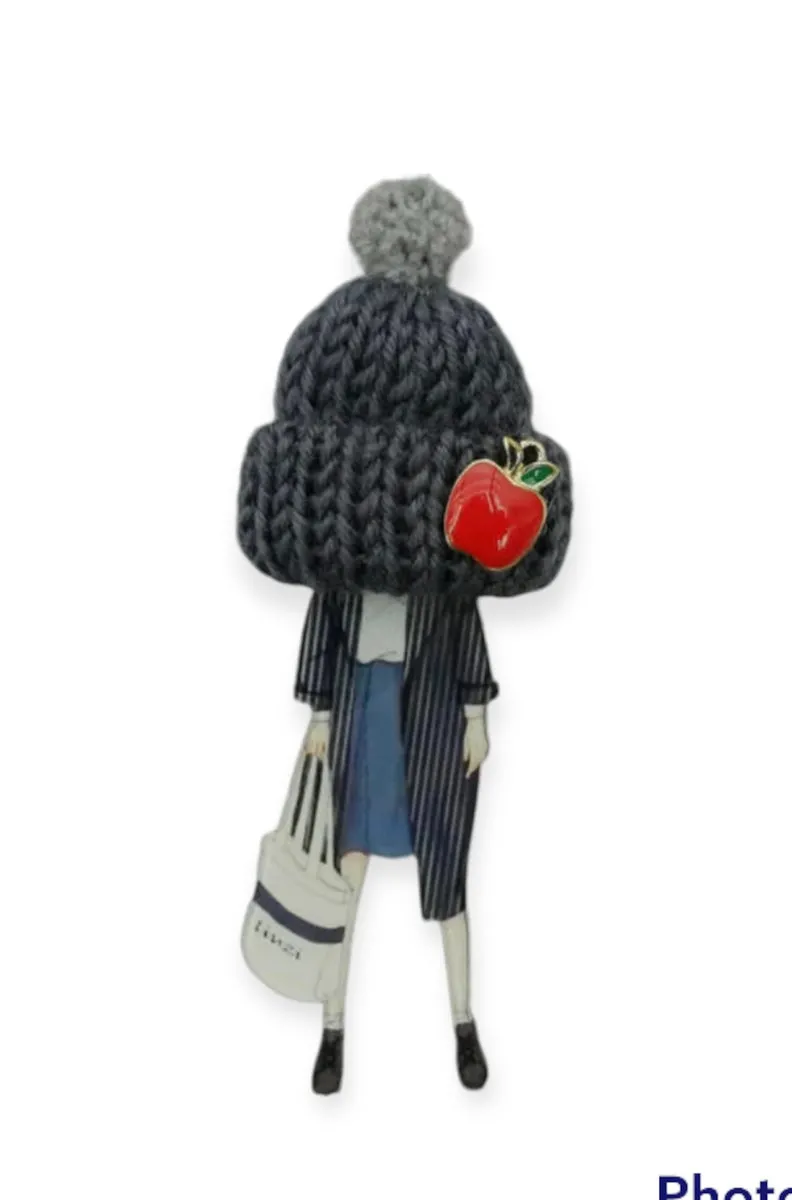 Spilla con modella fashion  e cappello in lana con ponpon e mela