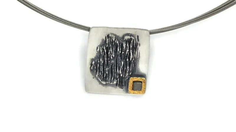 Ciondolo in argento e argento annerito con un diamante grezzo